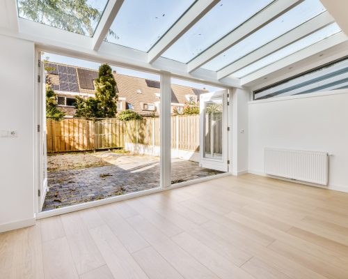 Luxurious empty room with door and parquet floor