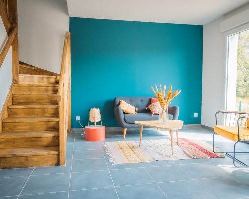 A beautiful interior design of a modern living room in the first floor in blue and yellow colors